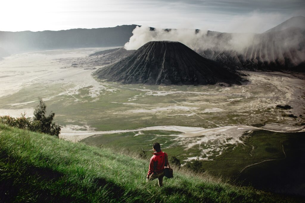 A person hiking close to volcanic mountains