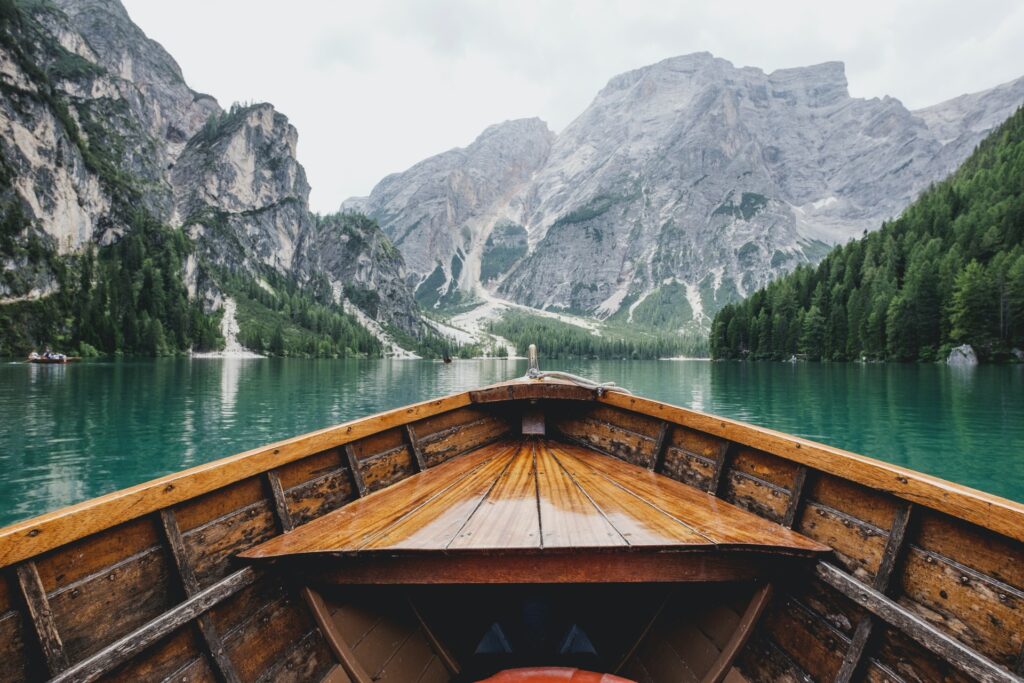A boat in a lake with mountains ahead