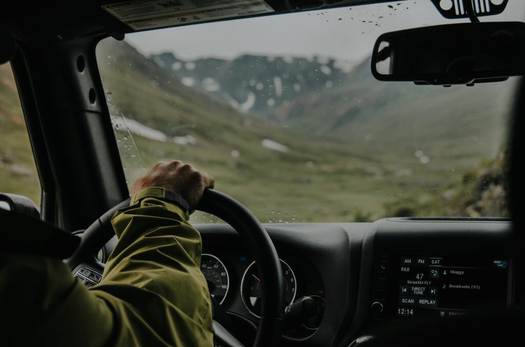 A person inside the car driving up a mountain