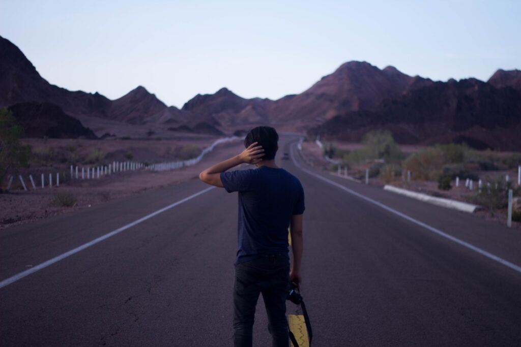 A person standing on a long road